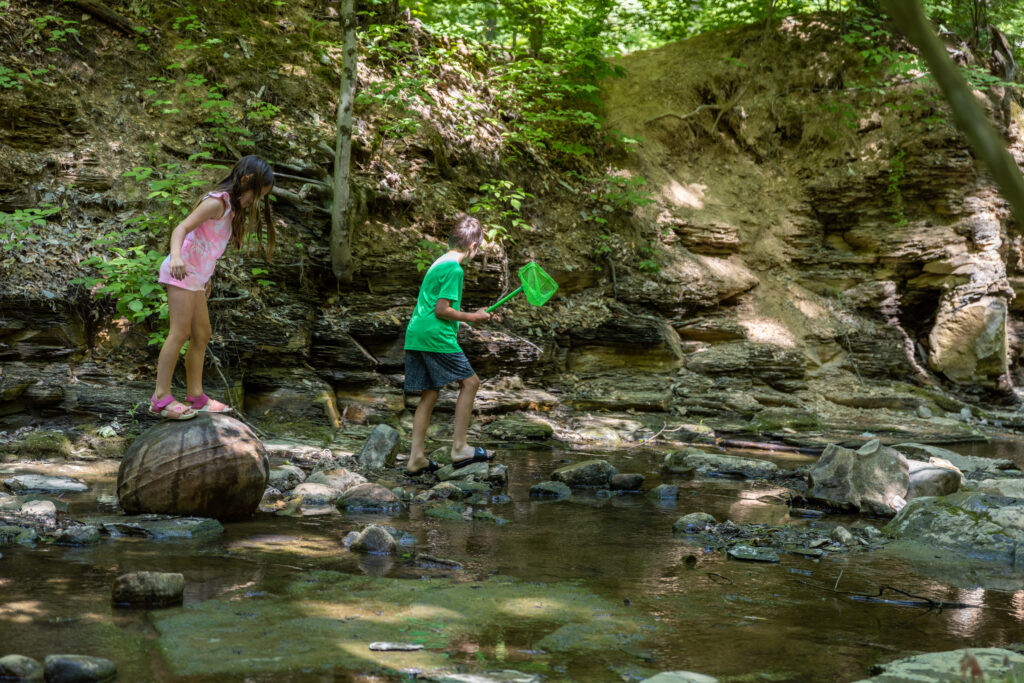 Kids playing in the creek at Shale Hollow