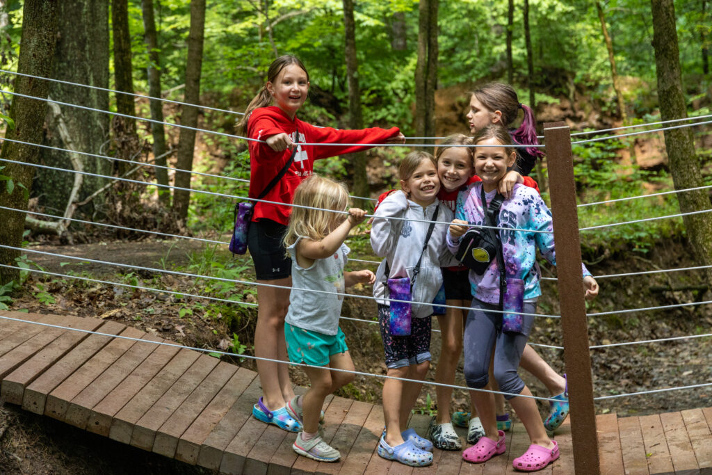 Kids on natural play area bridge