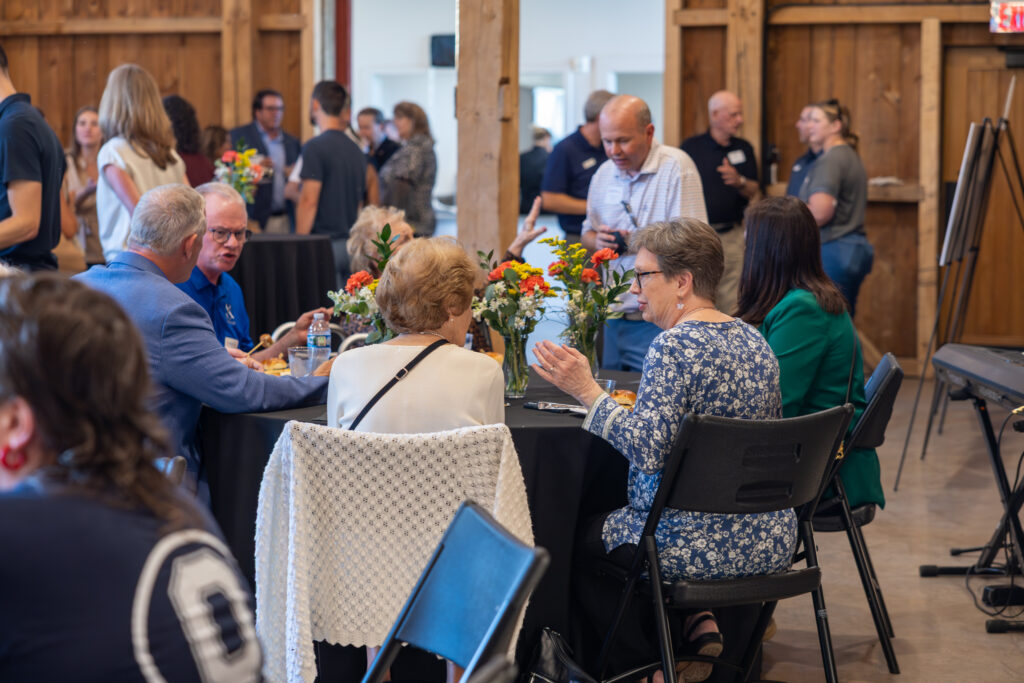 people mingling at table in event hall