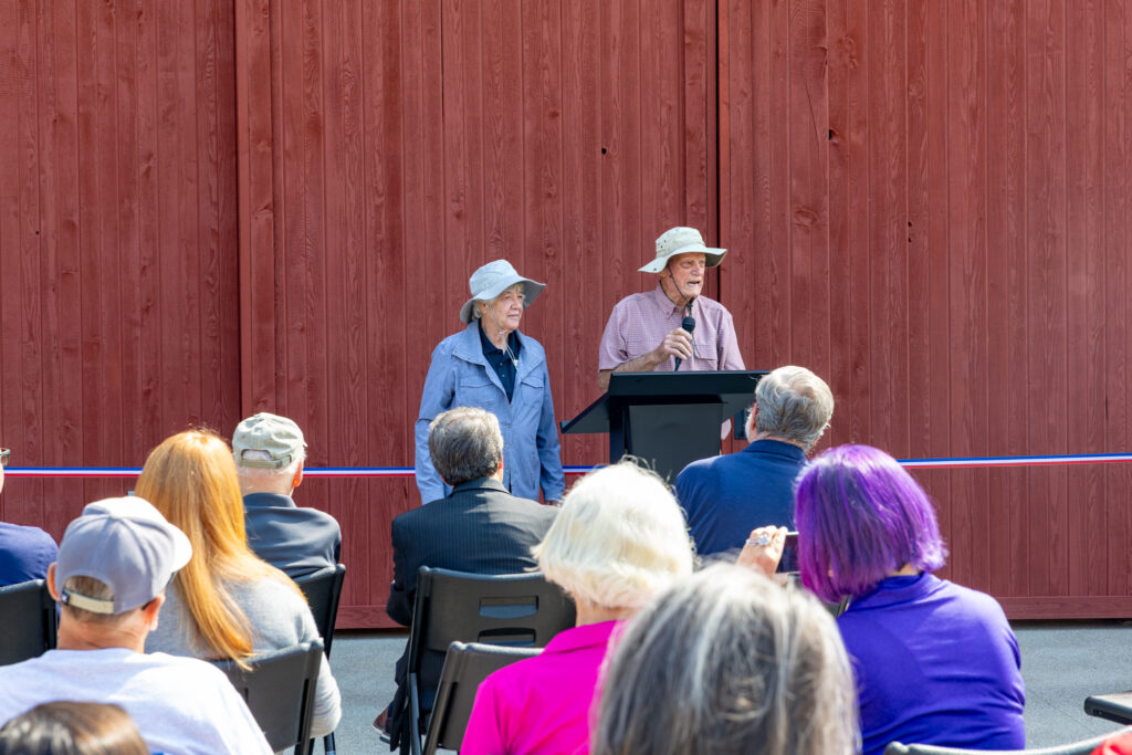 Bob and Sue Postle (former owners) speaking in front of barn