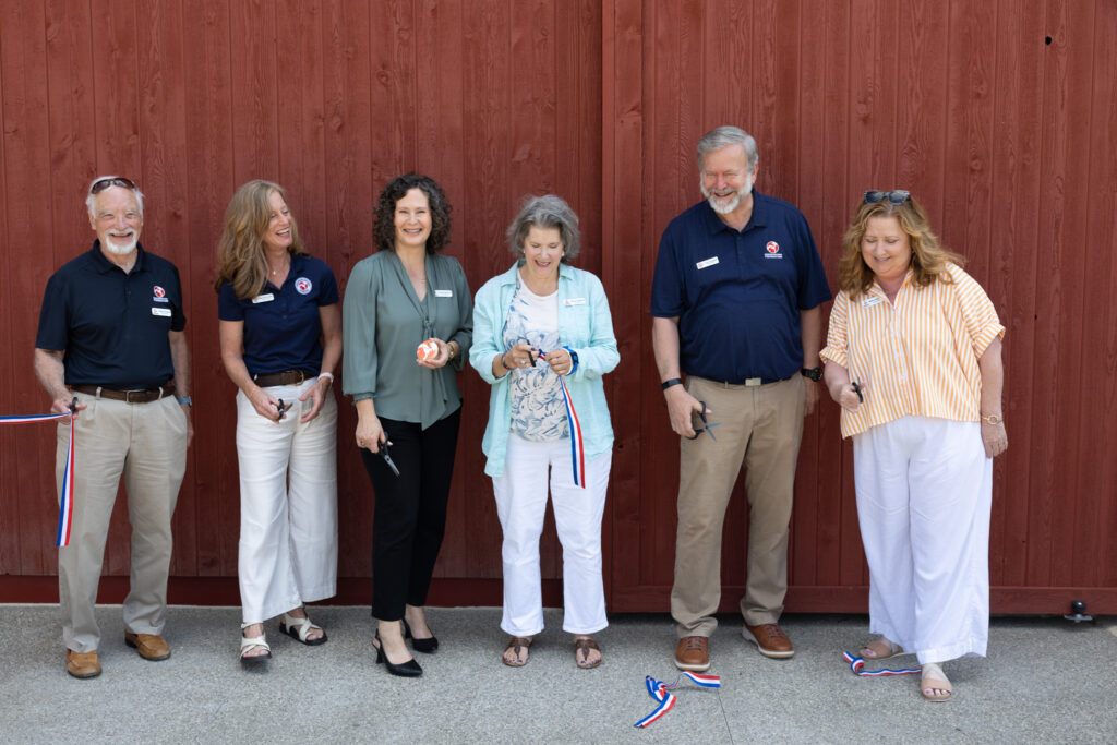 Preservation Parks Foundation members cutting ribbon in front of barn